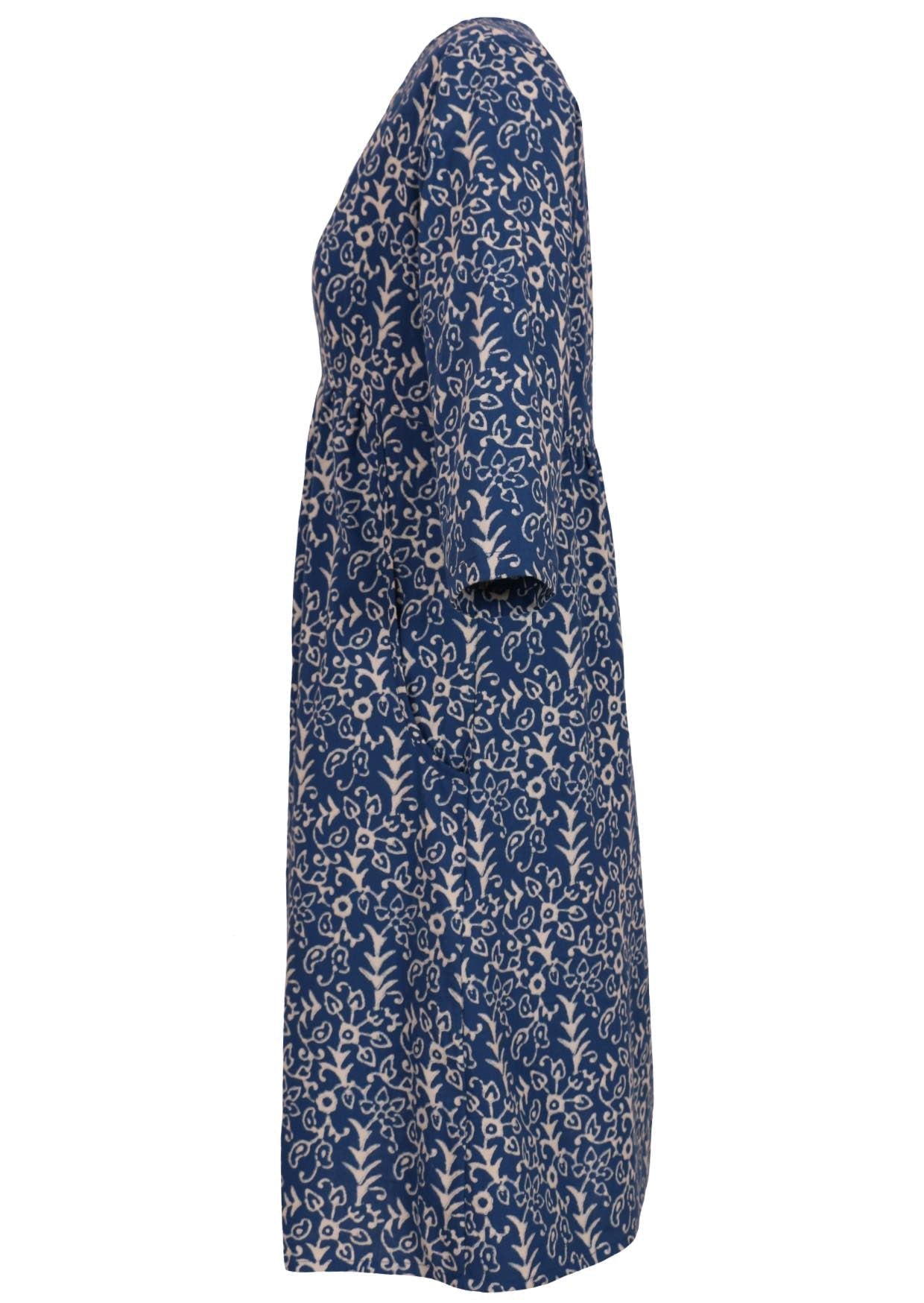 Side mannequin photo of 3/4 sleeve cotton dress with small gathers in front, empire waistline and pockets