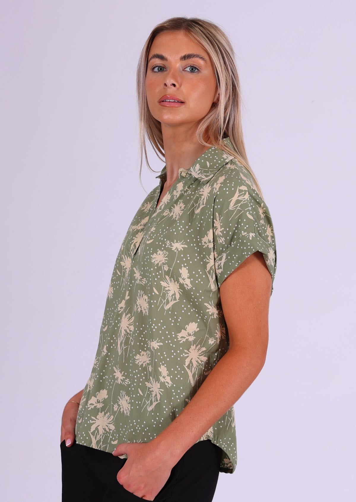 Cream floral silhouettes with white spots on a pale green base, cotton relaxed fit short sleeve top