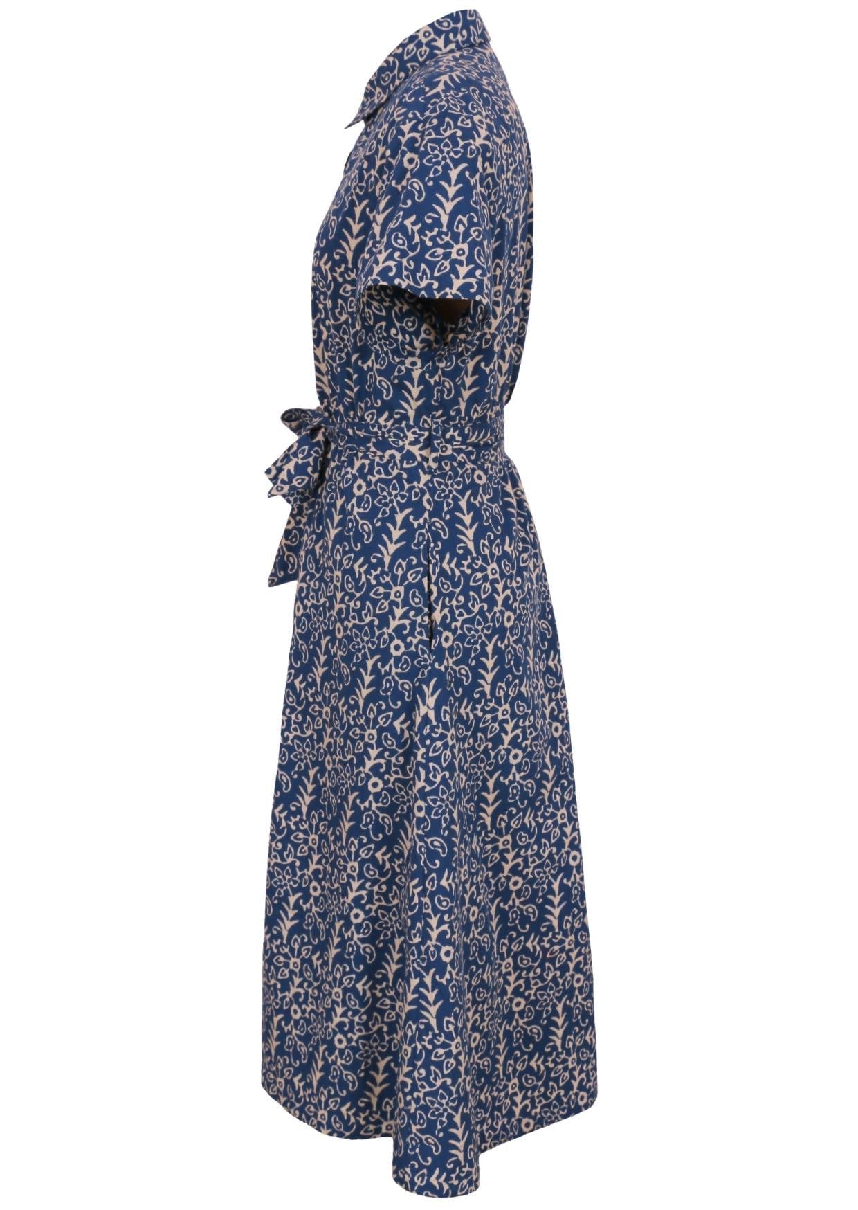 Side mannequin photo of button through shirt dress with collar, short sleeves and wide fabric waist tie