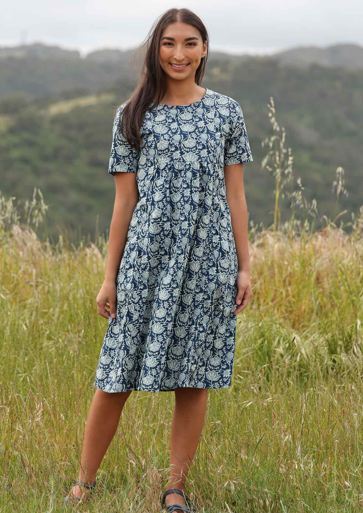 Woman styles blue based dress with sandals.