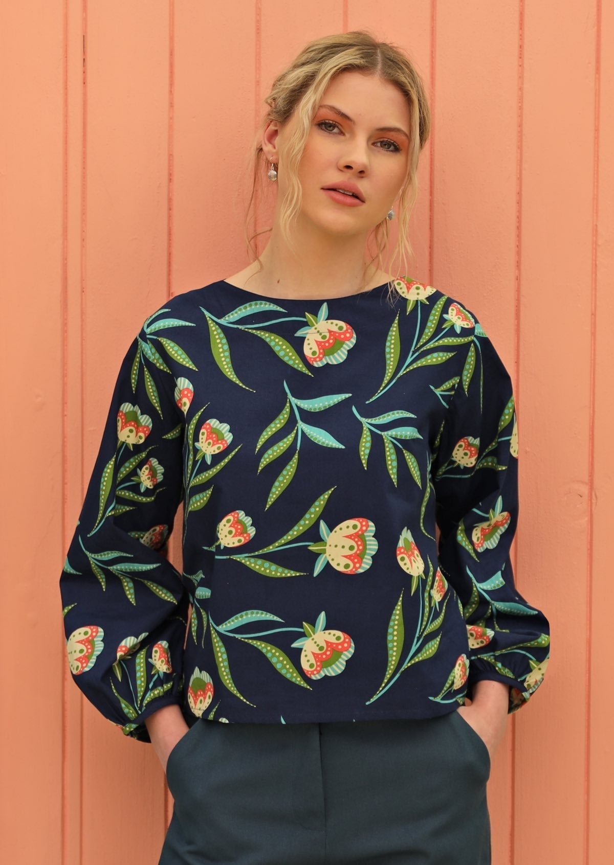 Woman wears top with round neckline.
