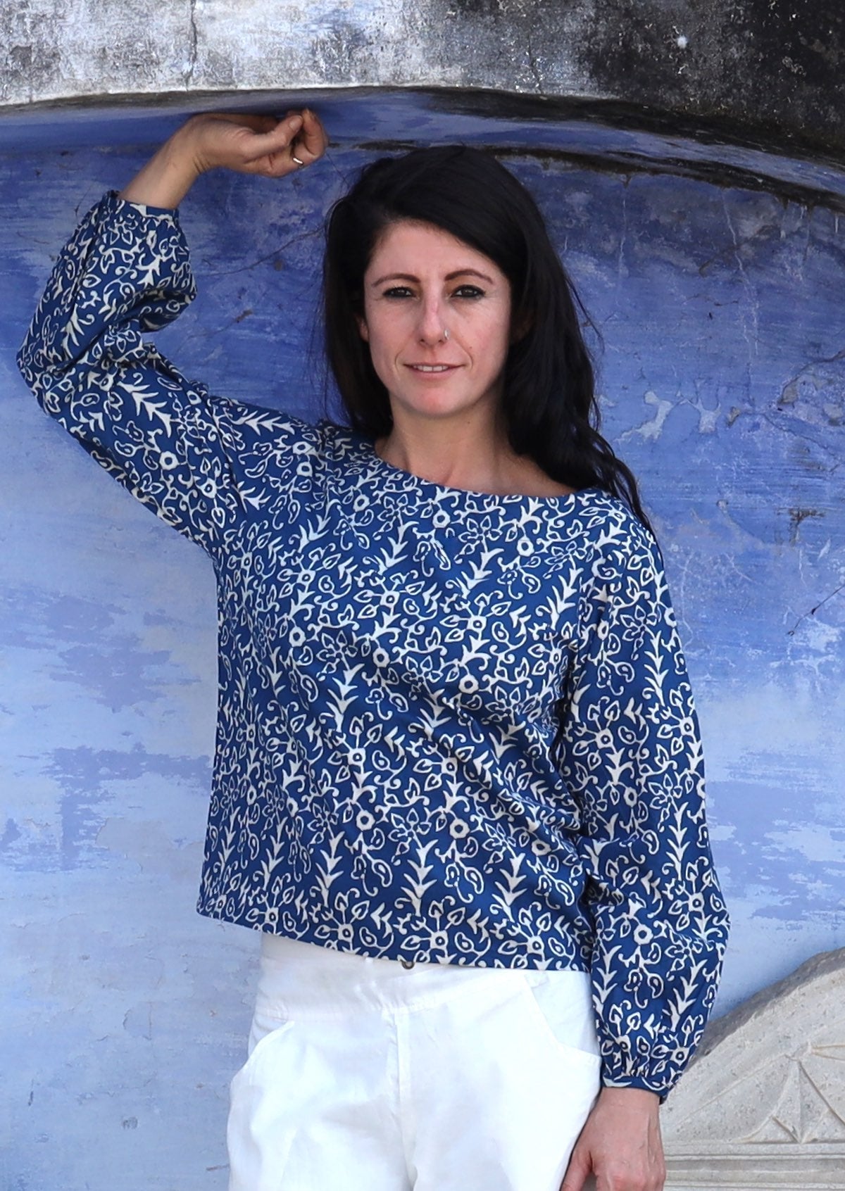 Woman wearing round boat neckline top with Bishop sleeves.