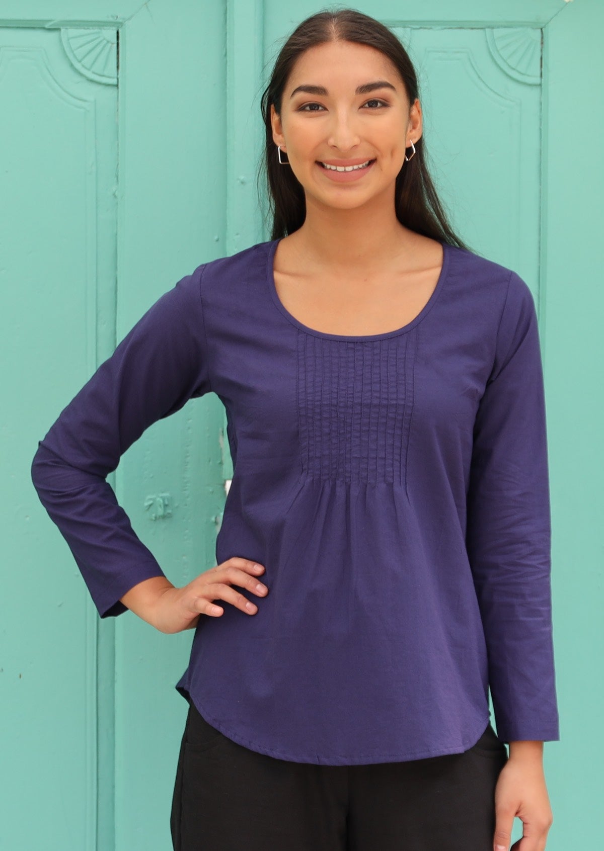 Model wears long sleeve cotton top in dark blue