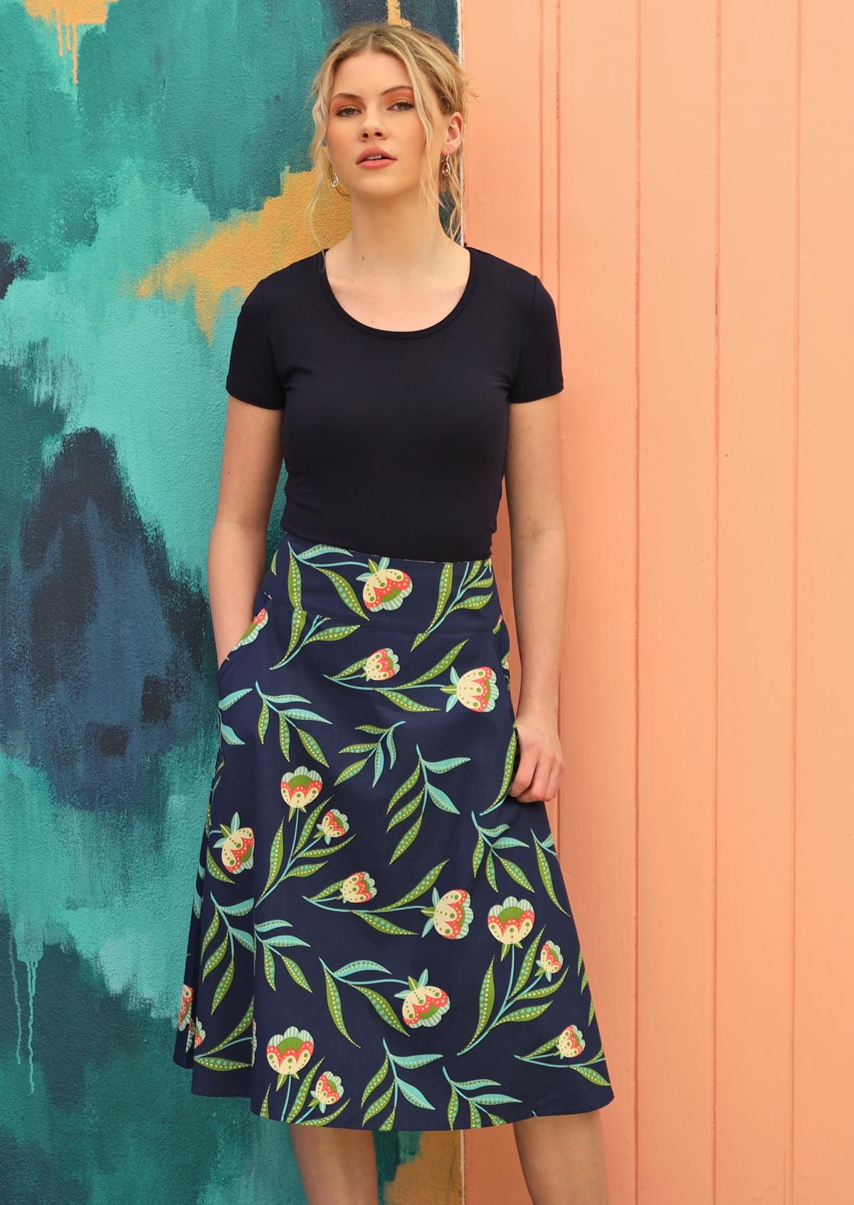 Woman wears skirt with pockets.