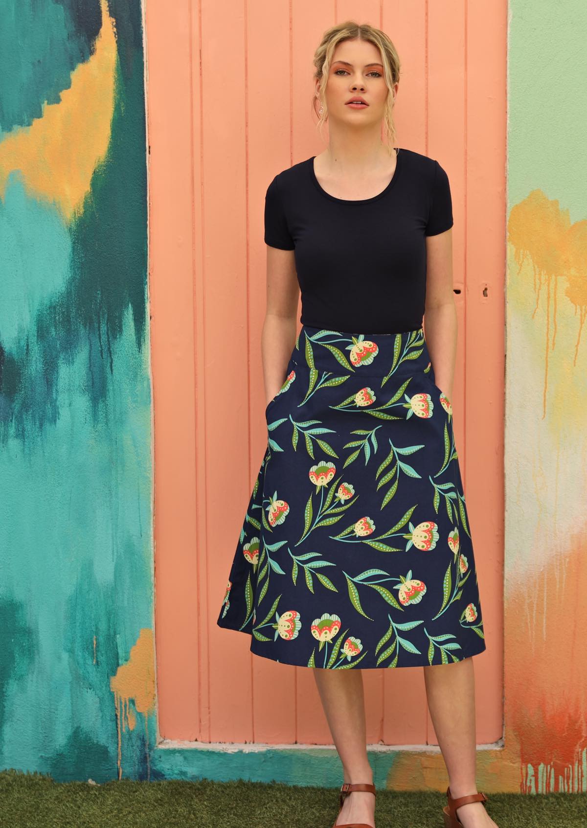 Model wears a skirt that ends below the knee.