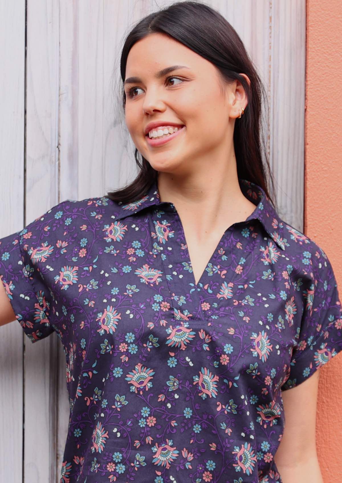 close up of woman with dark hair in cotton blouse with shirt collar in Indian print 