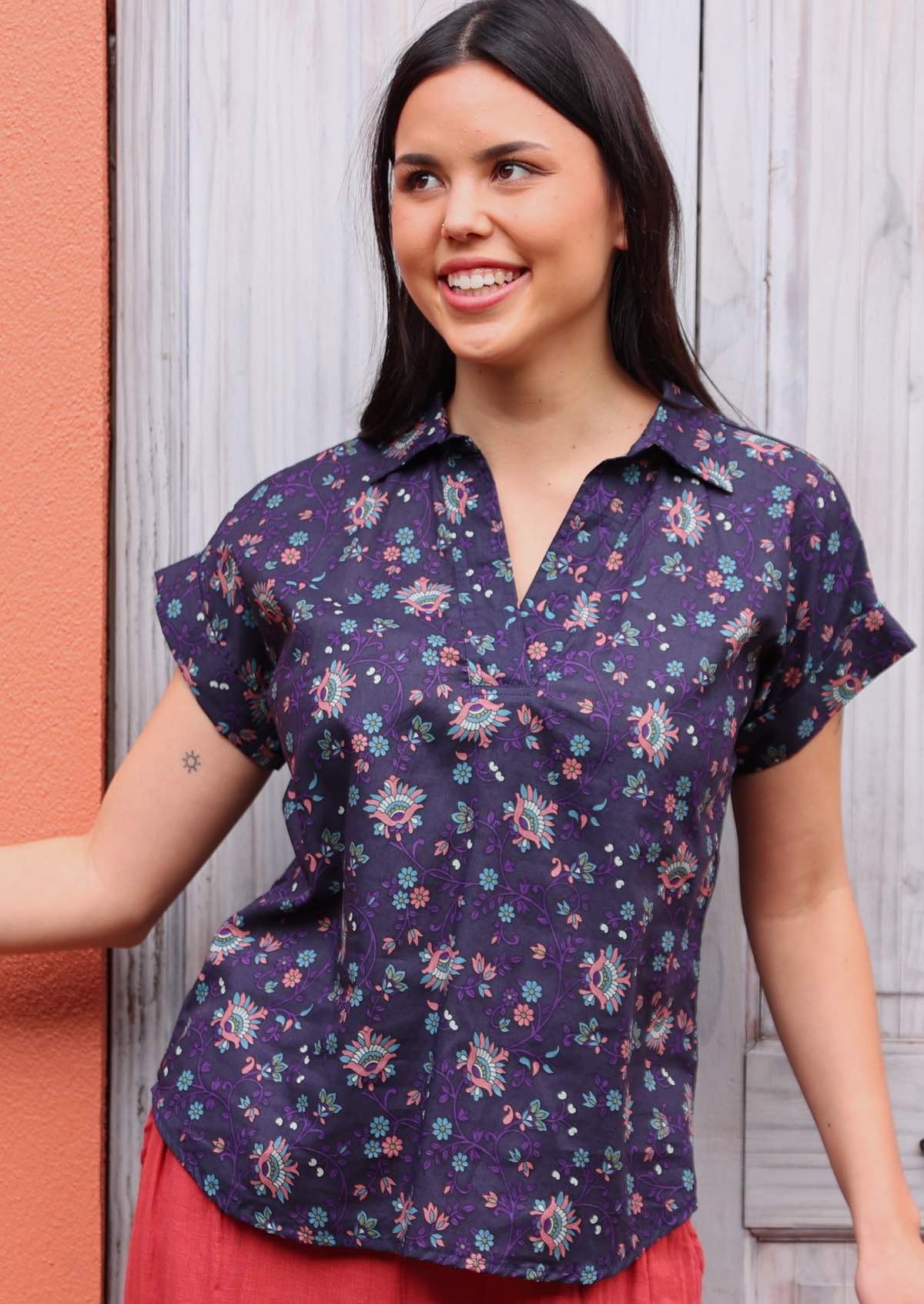 woman with dark hair in cotton blouse with shirt collar in Indian print 