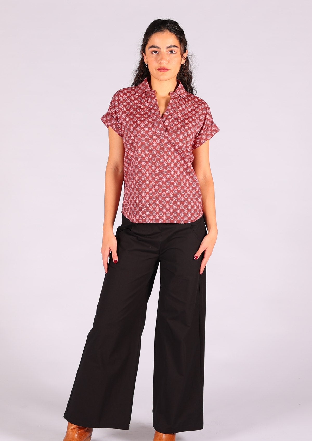 Model styles dark terracotta 100% cotton top with black pants. 