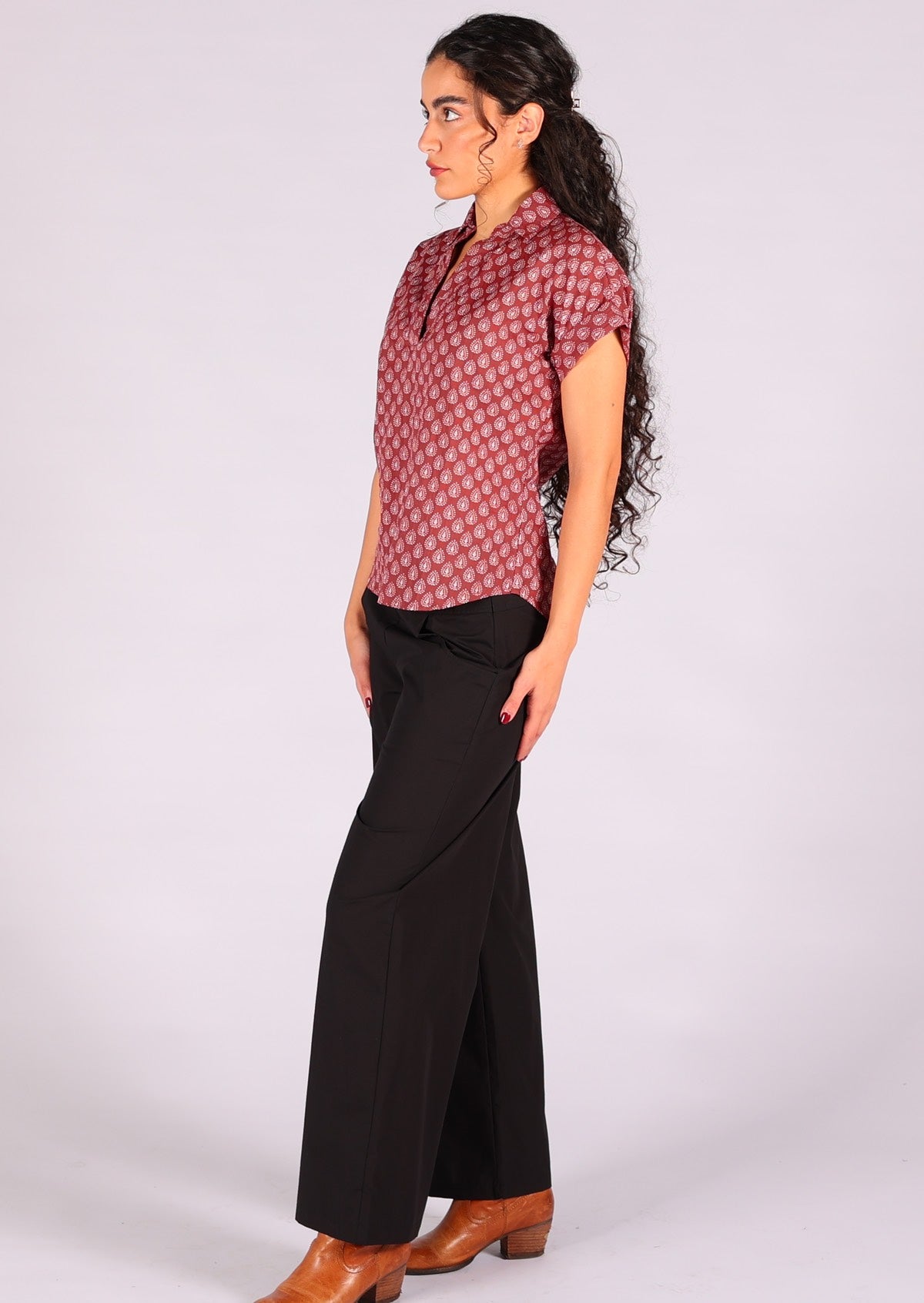 Model styles dark terracotta 100% cotton top with black pants. 