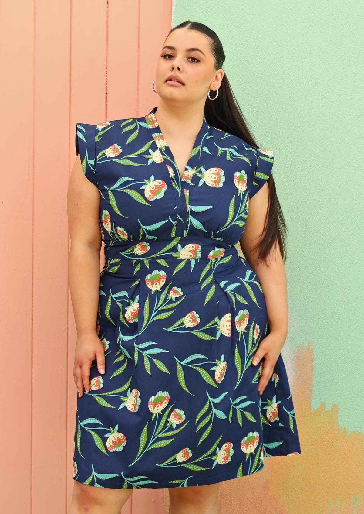 Model wears navy floral retro dress plus sized 