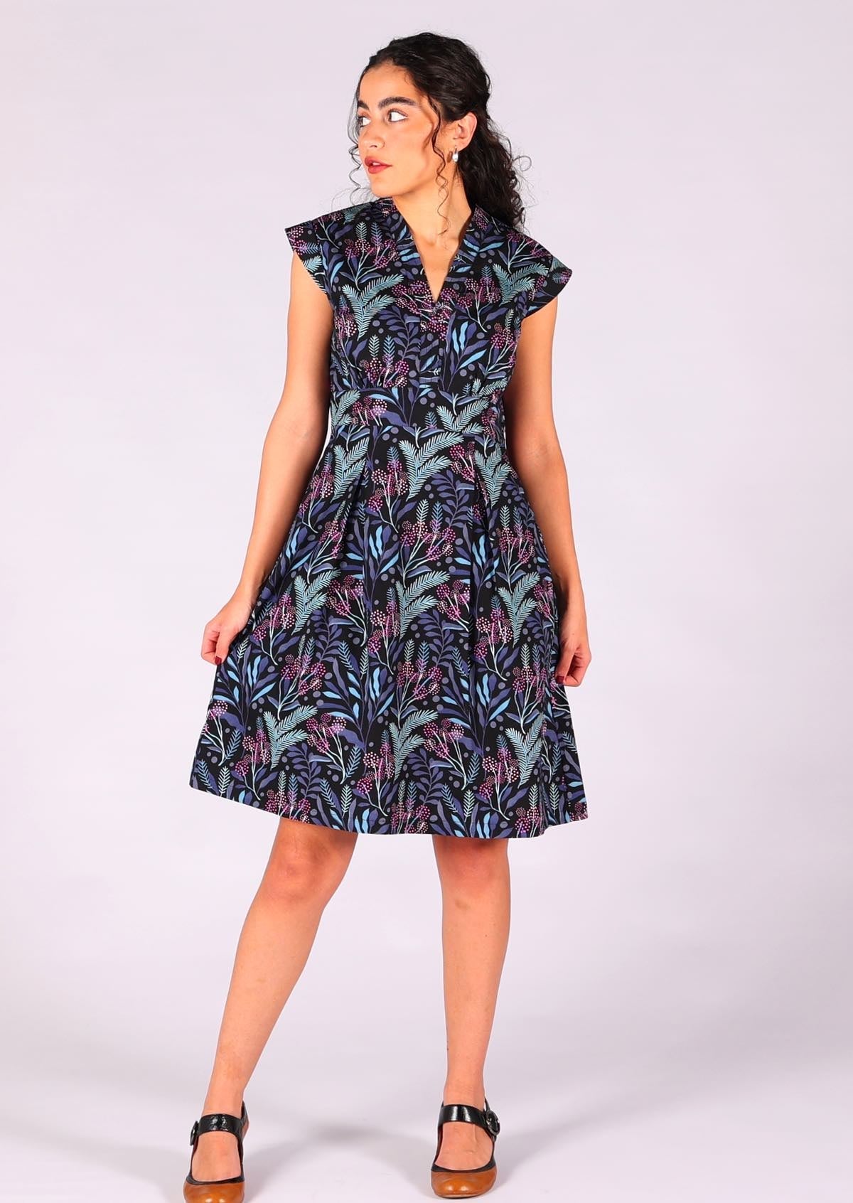 Gorgeous retro design cotton dress with box pleats and structured bodice with floral print on black base