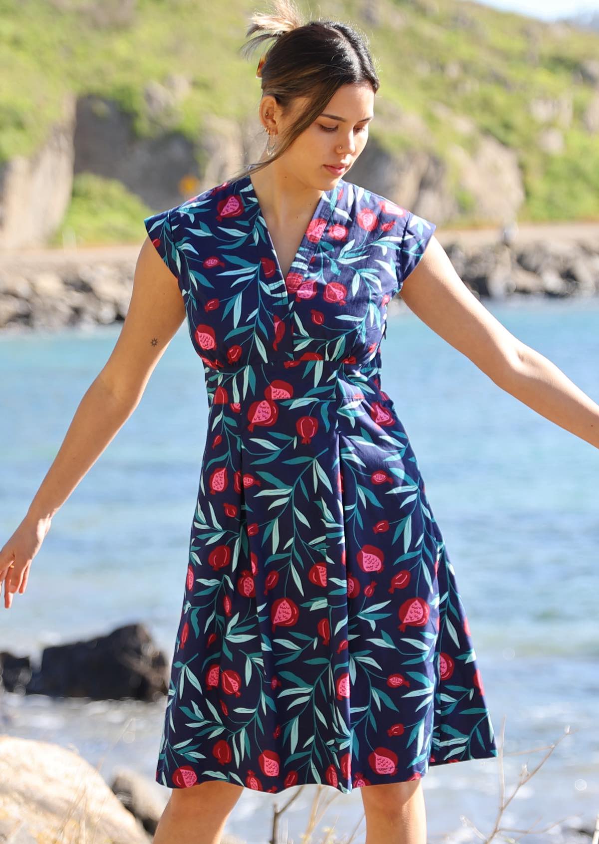 Woman wears knee length blue dress. 