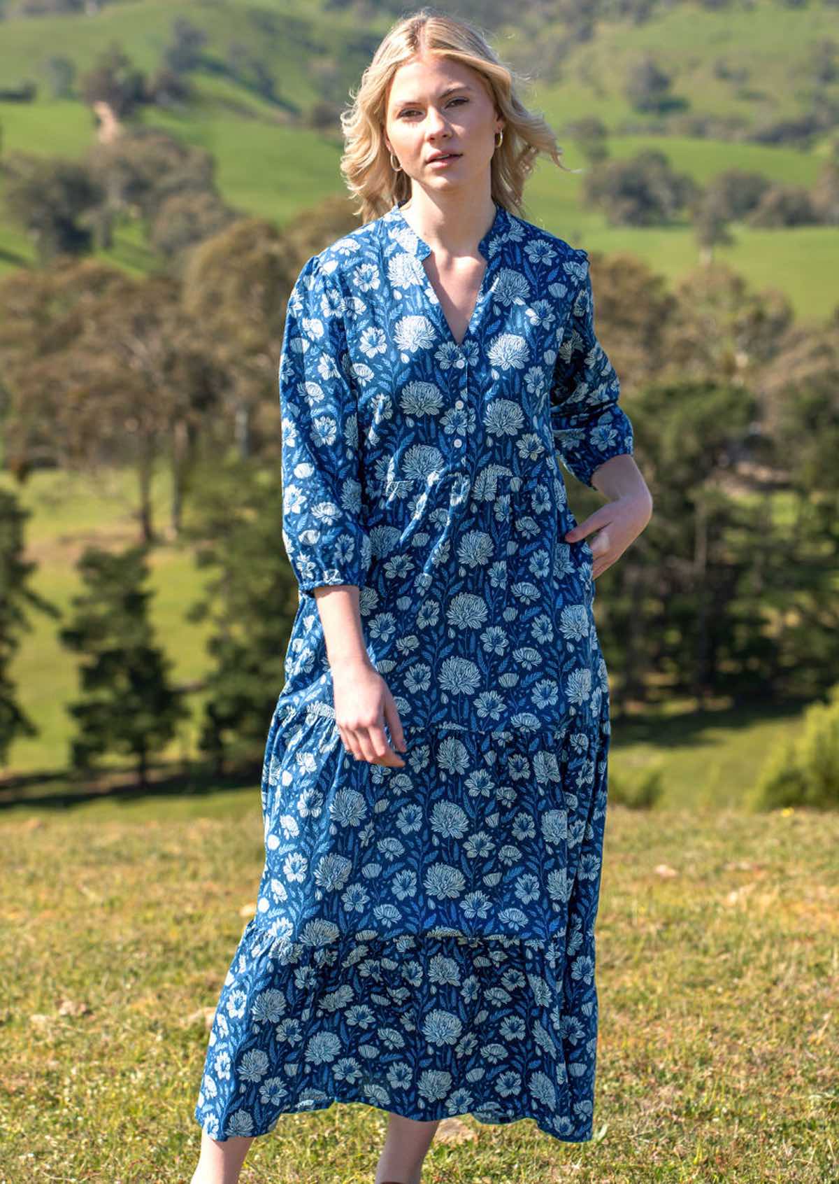 Full length photo of model in cotton maxi dress with relaxed fit three tiered skirt and hidden side pockets