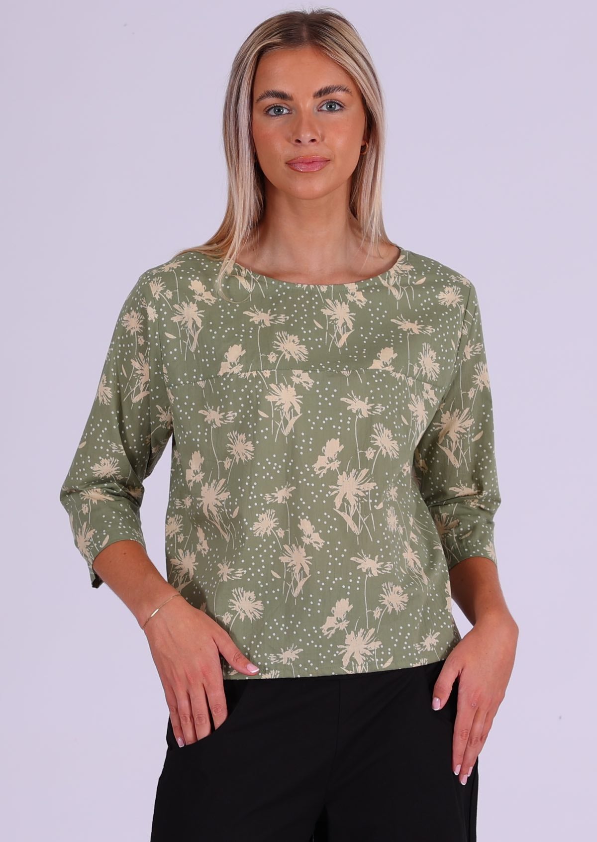 Model wears relaxed fit cotton top with 3/4 sleeves and round neckline in pale green and cream floral print