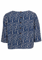Back mannequin photo of cotton 3/4 sleeve boxy top with decorative buttons down the centre of the back 