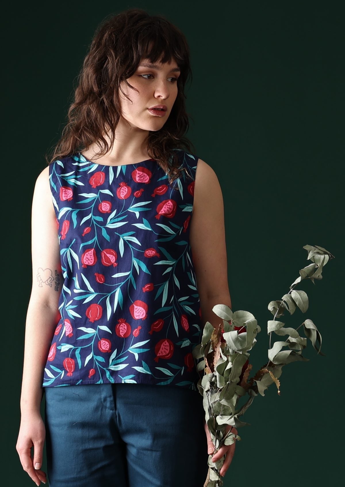 Model wears 100% cotton sleeveless top.