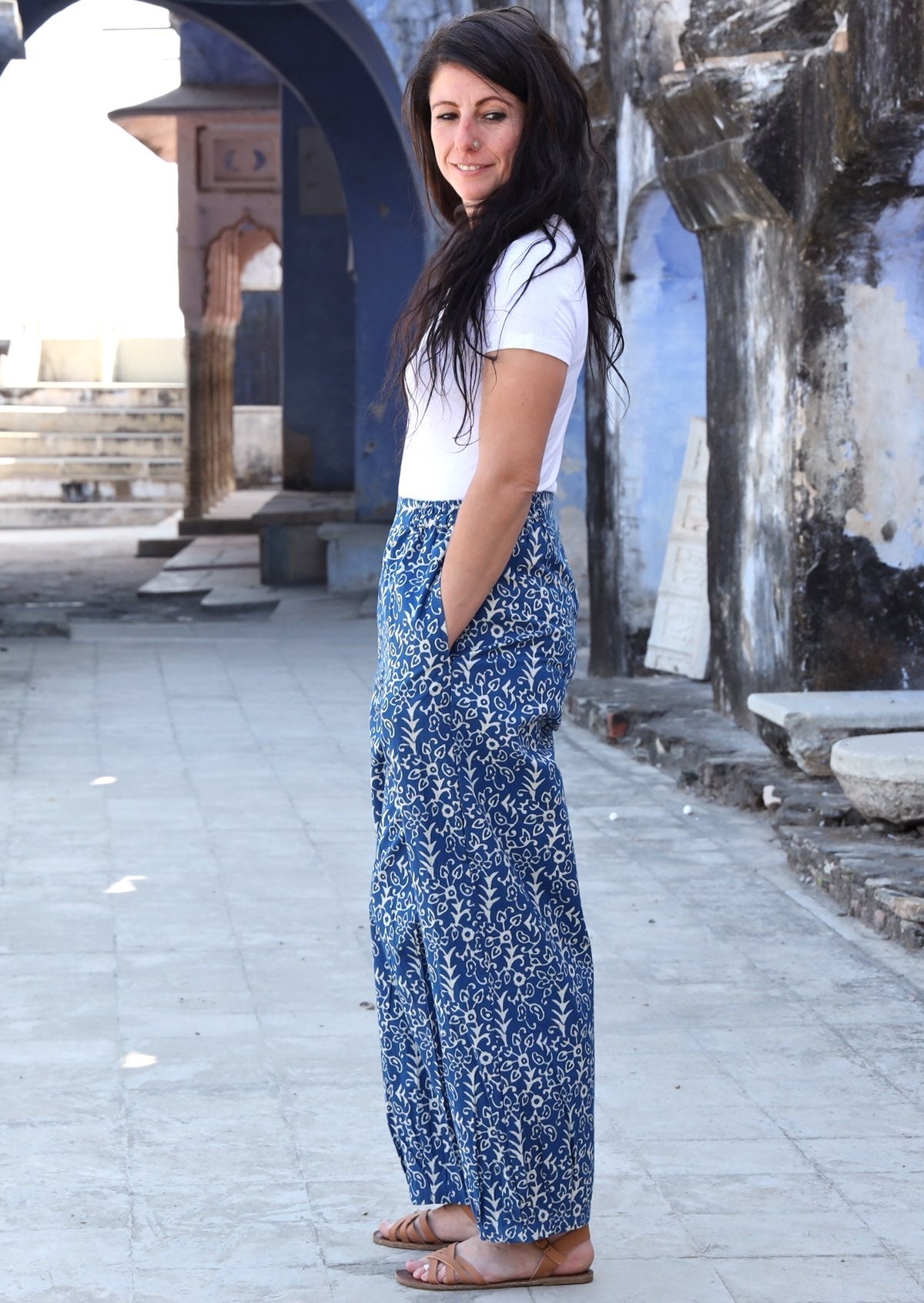 Woman standing sideways with hand in pocket wearing blue Indian 100% cotton pants