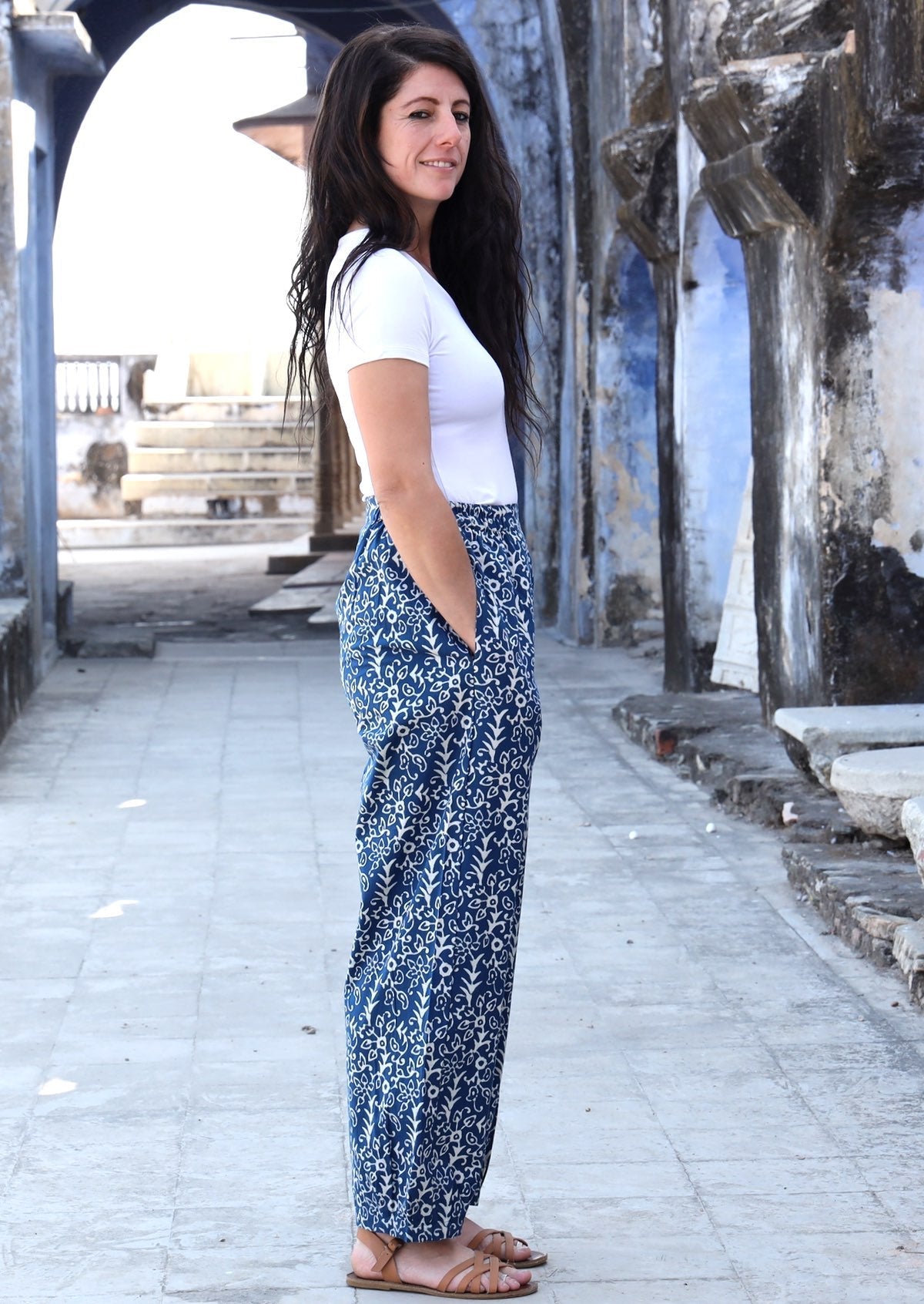 Woman standing sideways with hand in pocket wearing blue and white Indian 100% cotton pants