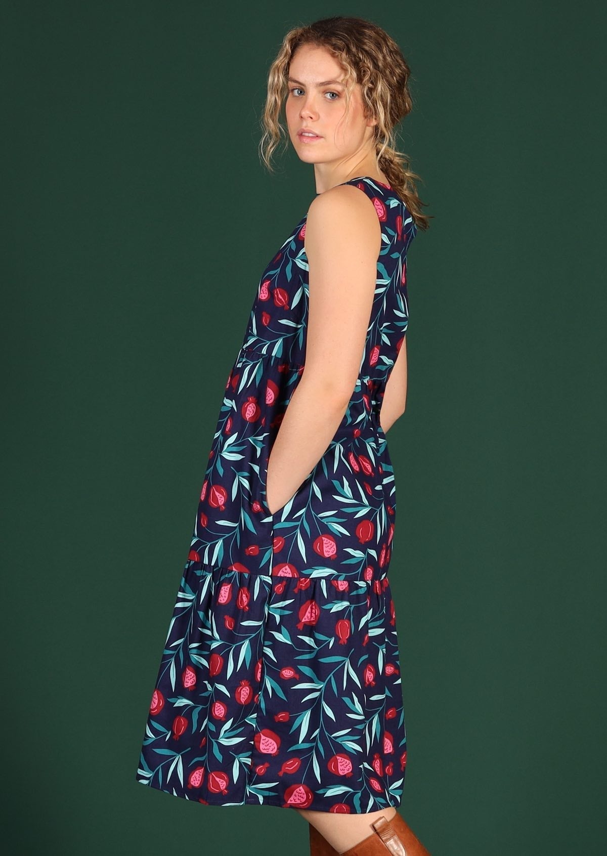 Women wears blue fruit print dress.