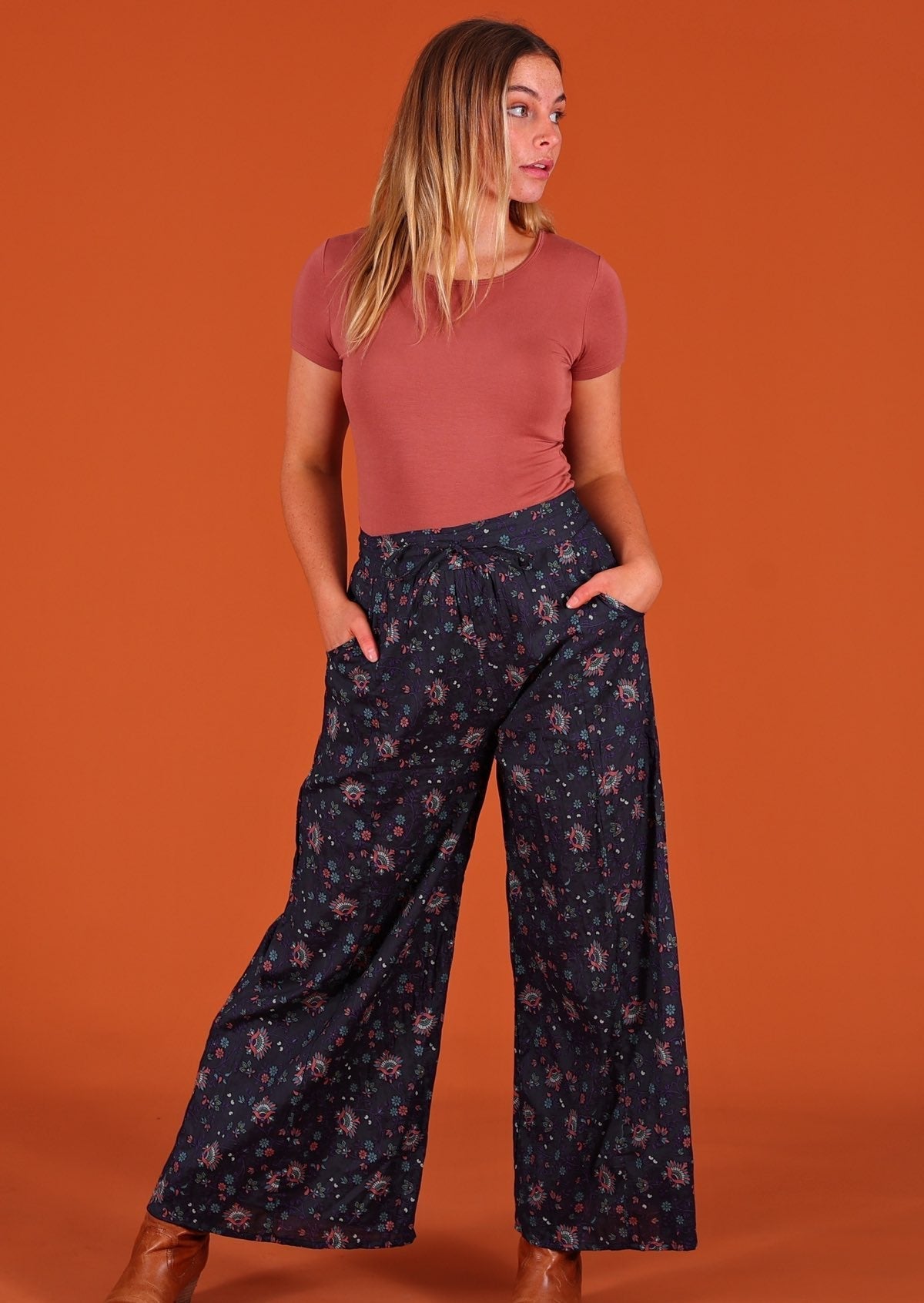 Model wearing Janis Pant Eventide 100 percent cotton wide legged women's palazzo with hands in pockets