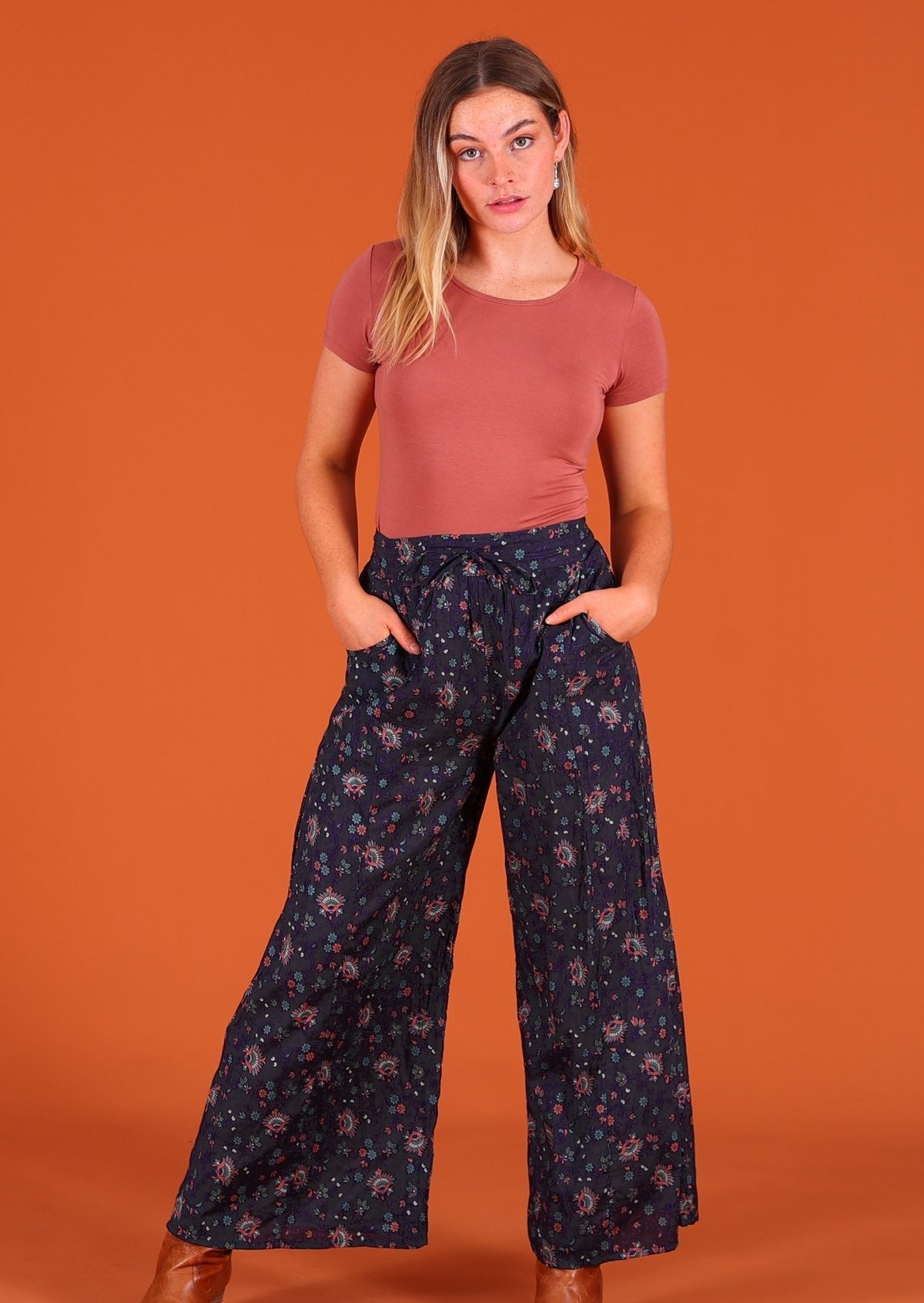 Model wearing Janis Pant Eventide 100 percent cotton wide legged women's palazzo with hands in pockets