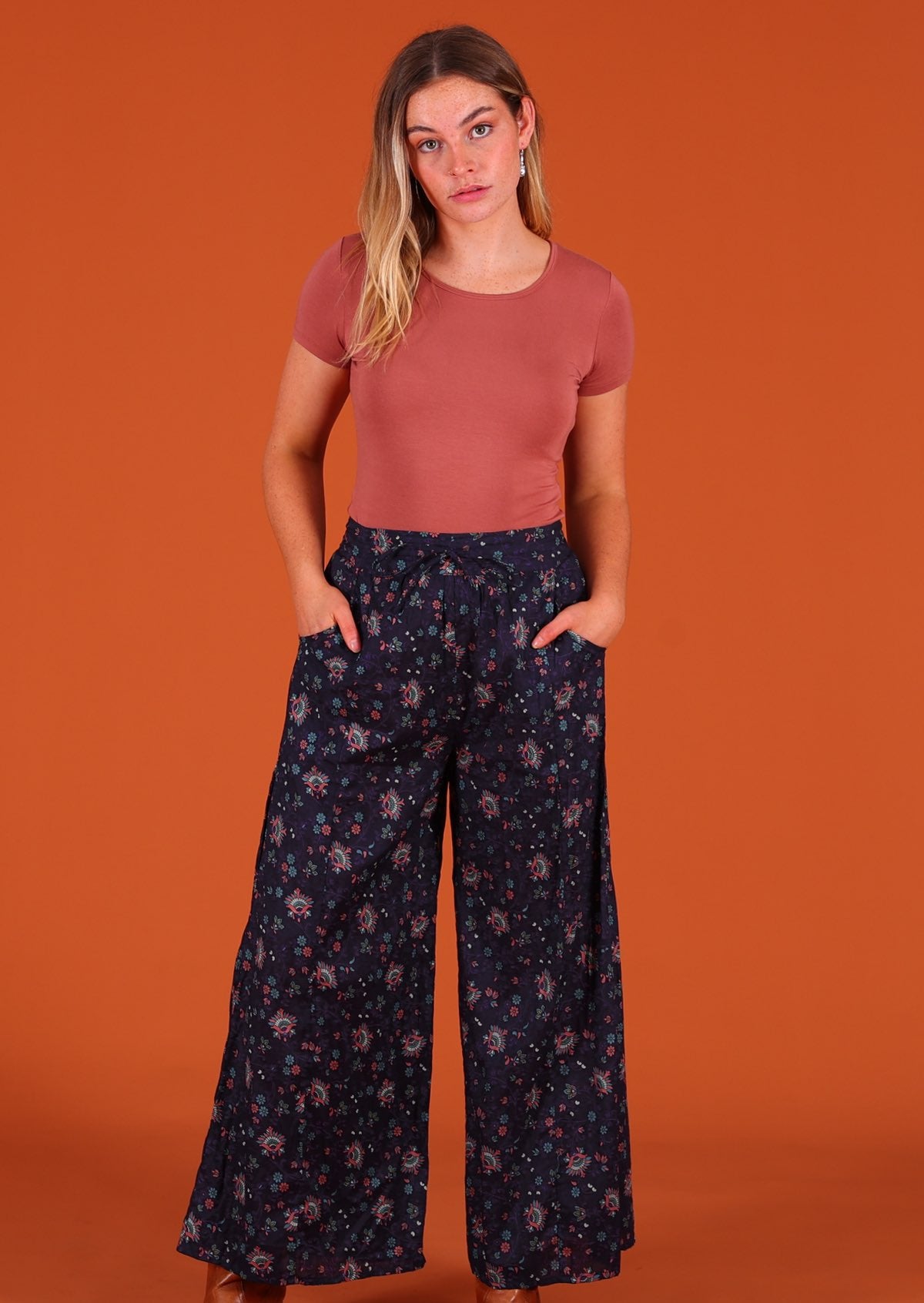 Model wearing Janis Pant Eventide 100 percent cotton wide legged women's palazzo with hands in pockets