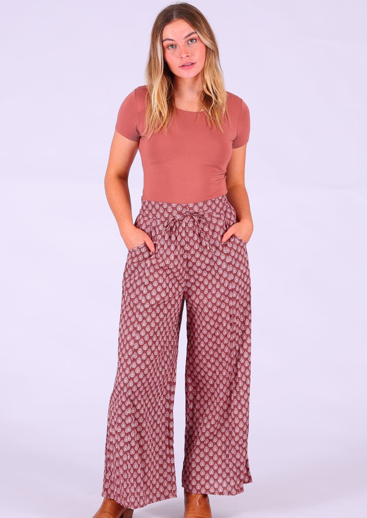 Model wearing Janis Pant Henna 100 percent cotton wide legged women's palazzo with hands in pockets