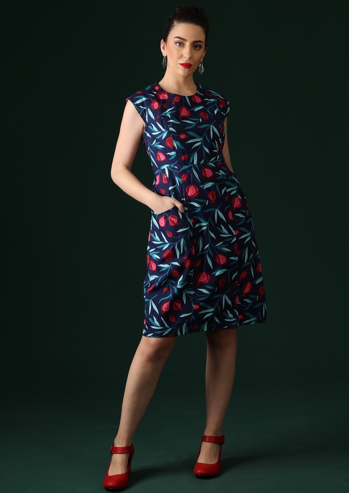 Model wears knee length dress with cap sleeves.