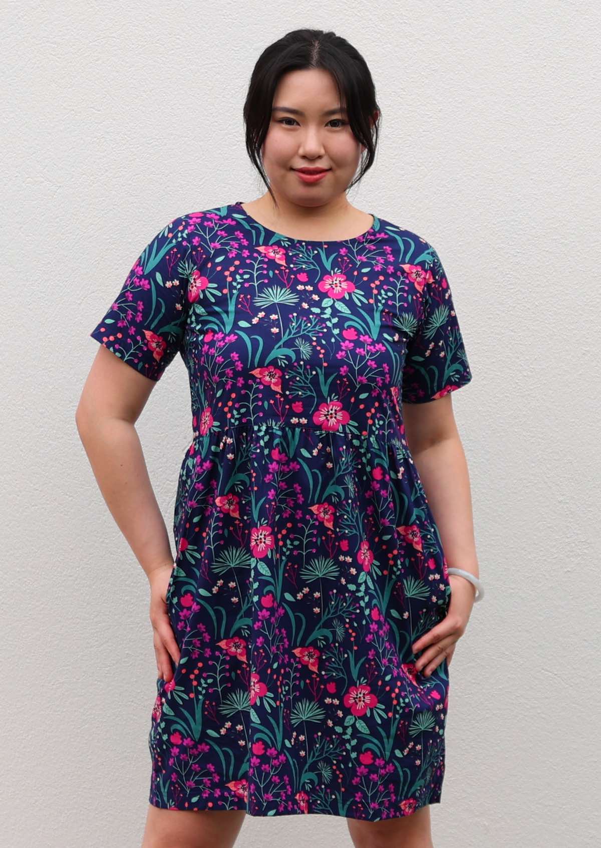 woman in loose fit purple, navy and pink floral print 100% cotton dress