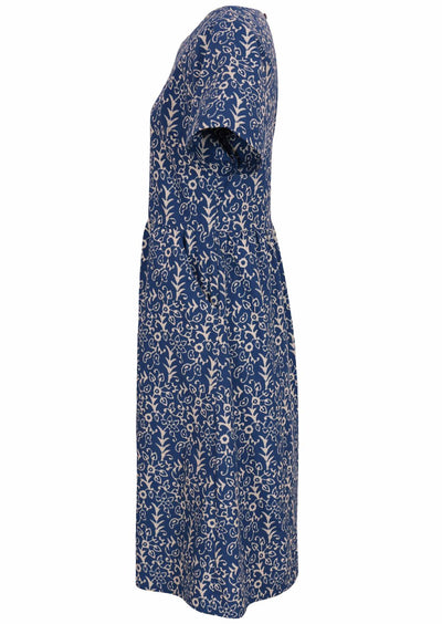 Side mannequin photo of cotton dress  with hidden side pockets with blue base and off white floral print