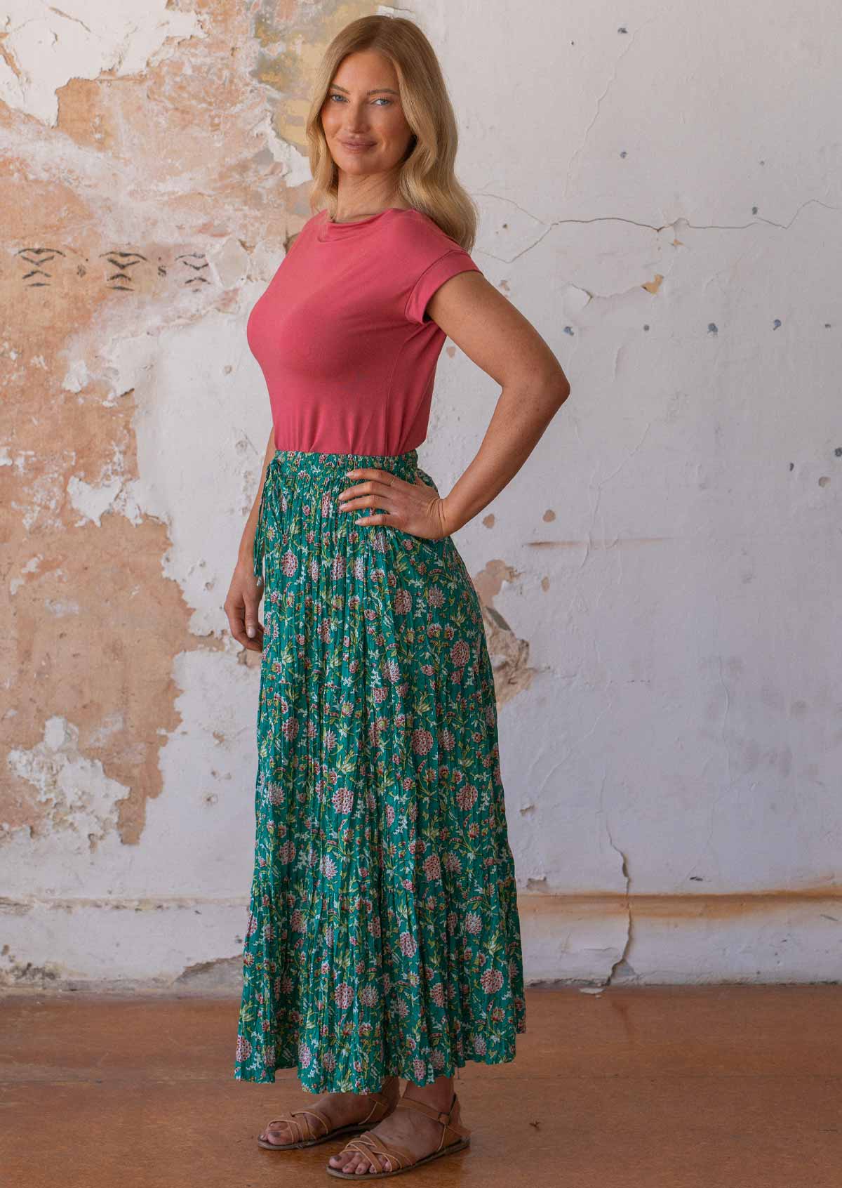 Woman poses in 100% cotton maxi skirt with three tiers and drawstring in floral print