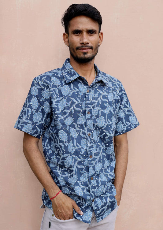 Man wears short sleeve cotton relaxed fit button through shirt in Indian inspired blue floral print