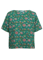 Front mannequin photo of cotton short sleeve relaxed fit top in floral print on jade green base