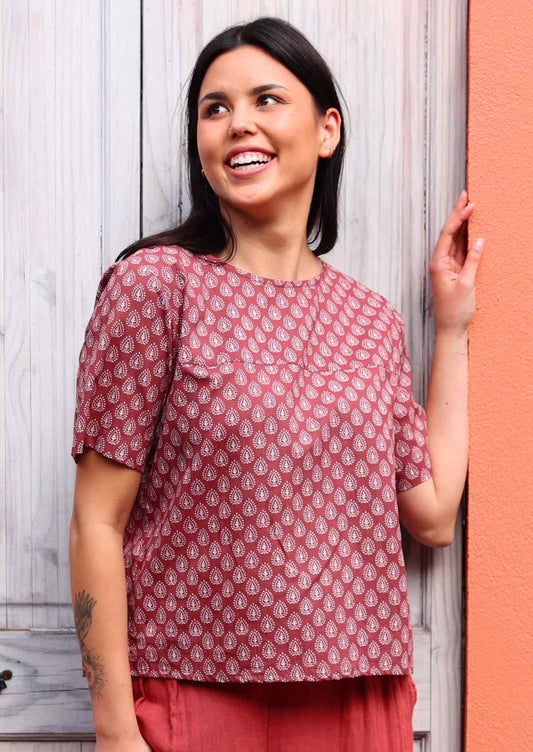 Model poses in terracotta and white print relaxed fit cotton top with T-shirt sleeves