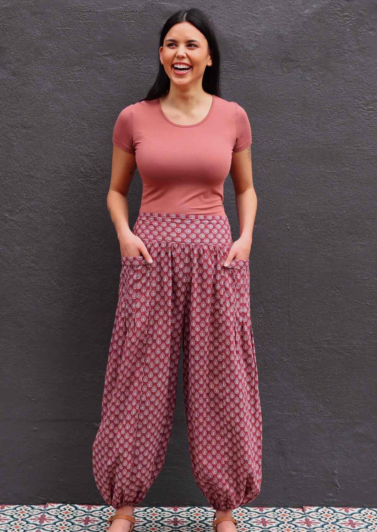 Model wearing 100 percent cotton harem pants with hands in pockets