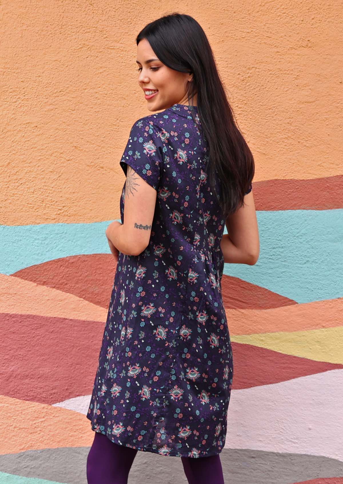 Model wearing short sleeve cotton dark purple tunic modelling back of tunic