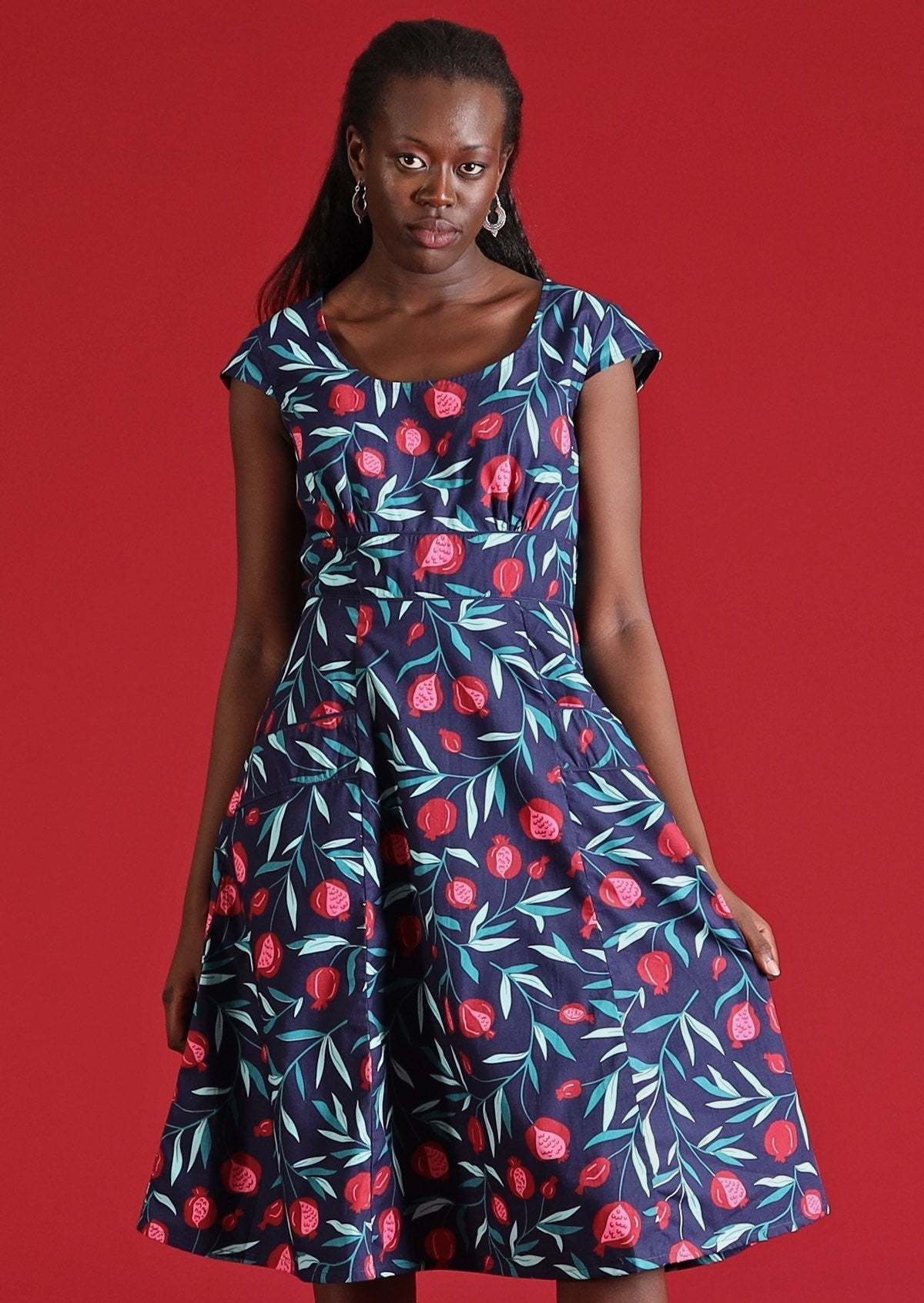 Model wears blue cotton dress with pockets 