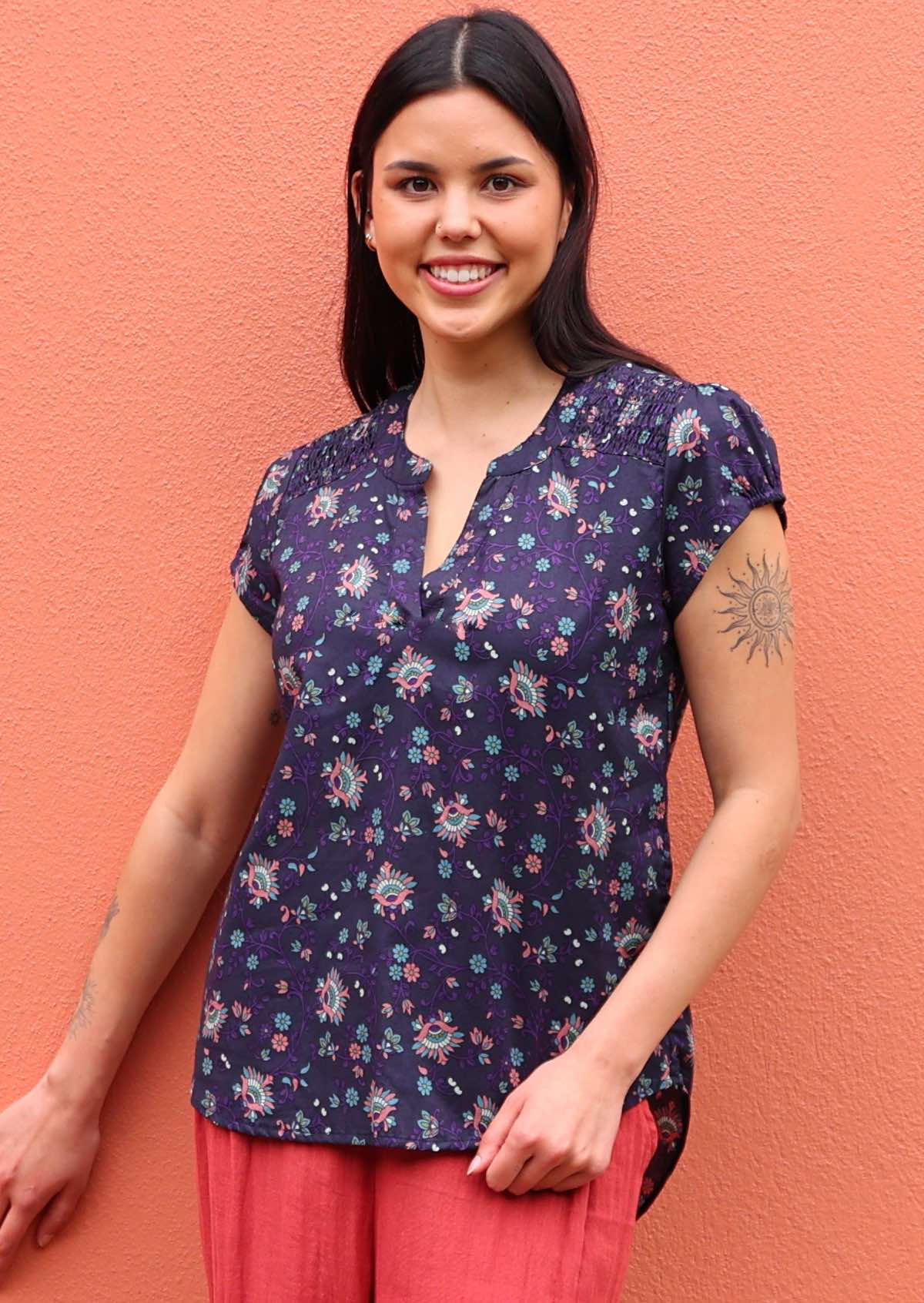 Model wearing capped sleeve cotton blouse with V-neck and mandarin collar in an Indian floral print 