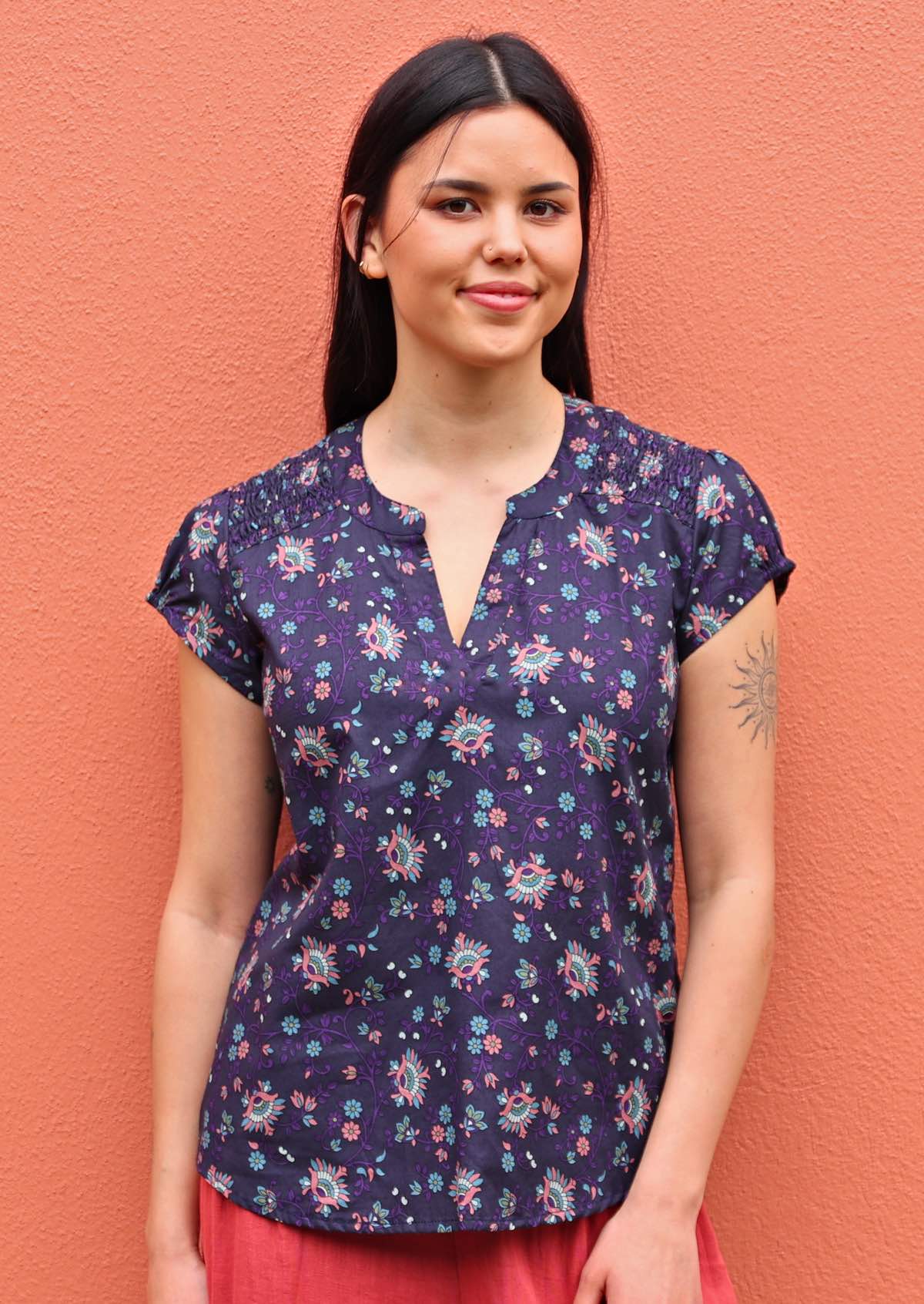 Model wearing capped sleeve cotton blouse in an Indian floral print 