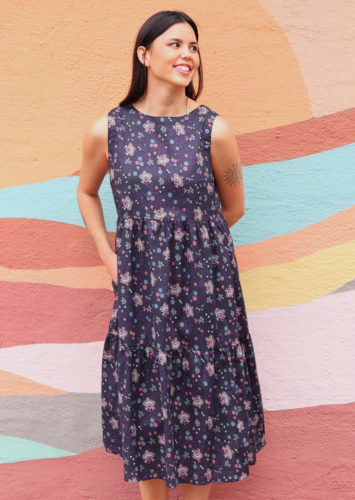 Model wearing Indian Cotton floral print dress with hands below the knee
