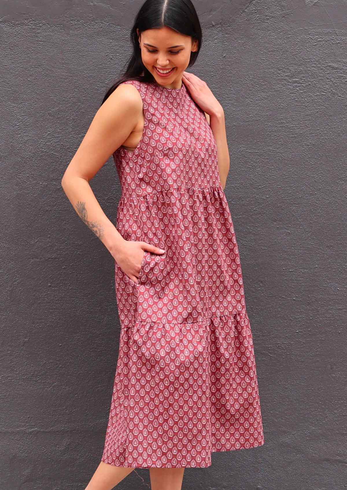 Woman with dark hair in Indian Cotton Sundress with three tiers and hand in pockets 