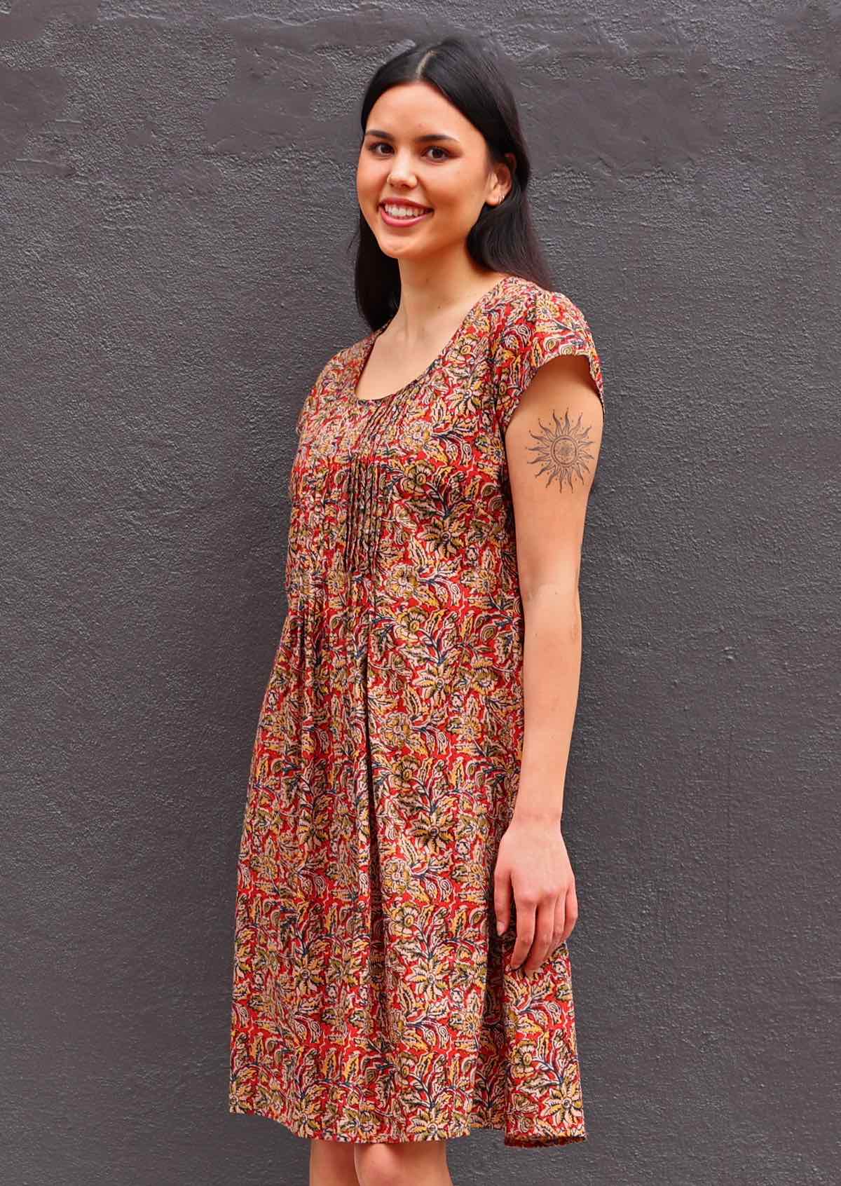 Woman with dark hair wearing Tulsi Dress Wild Spice Indian print cotton sundress