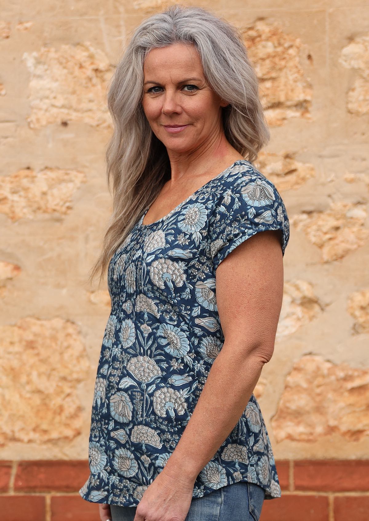 100% cotton blue based floral print top with sweet little pleats across the chest