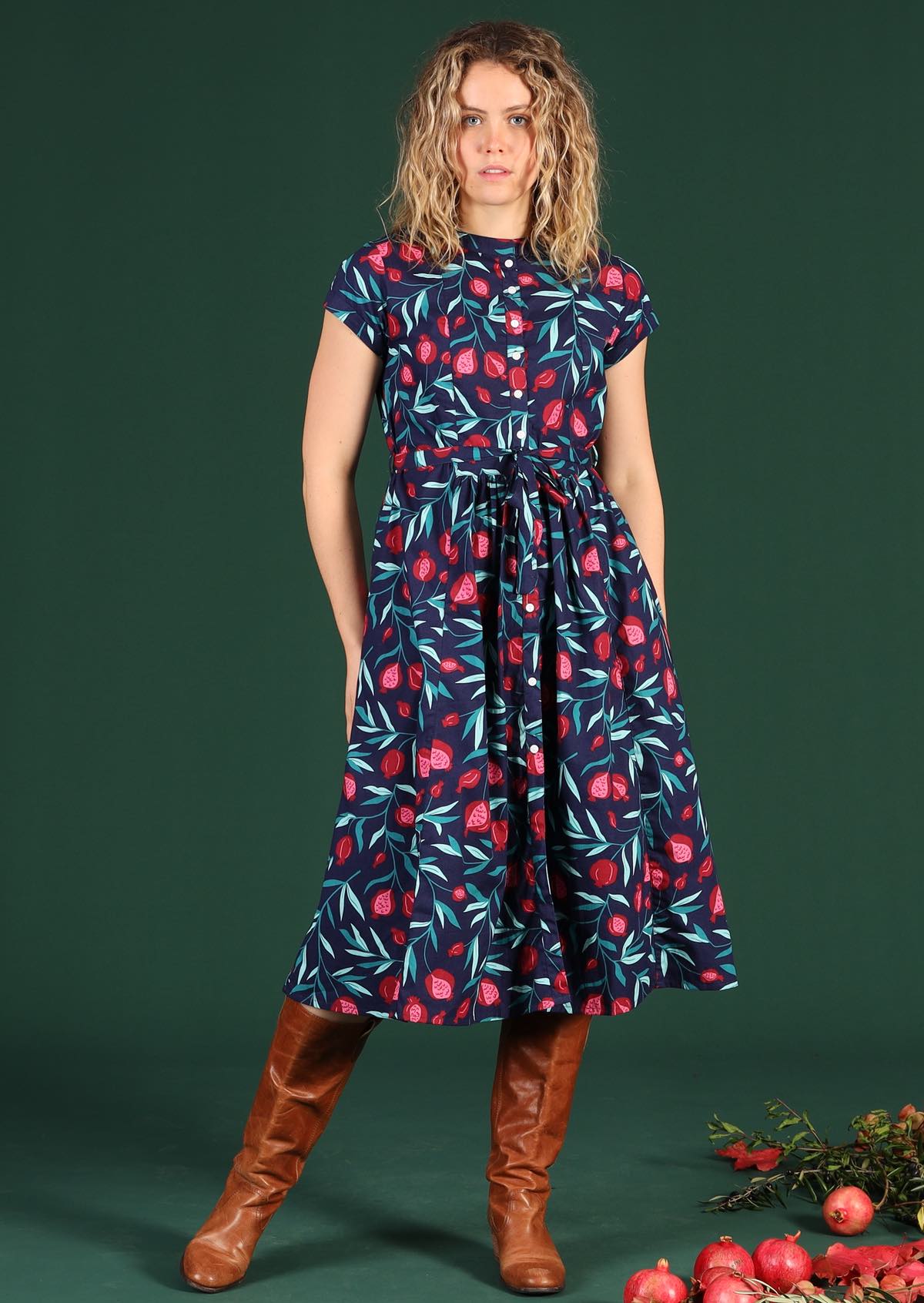 Women wears long pomegranate print dress with pockets