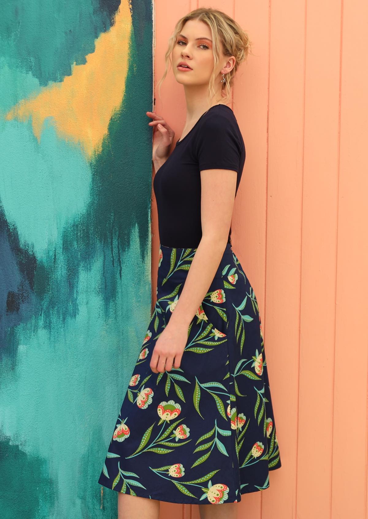 Model wears A-line style skirt. 