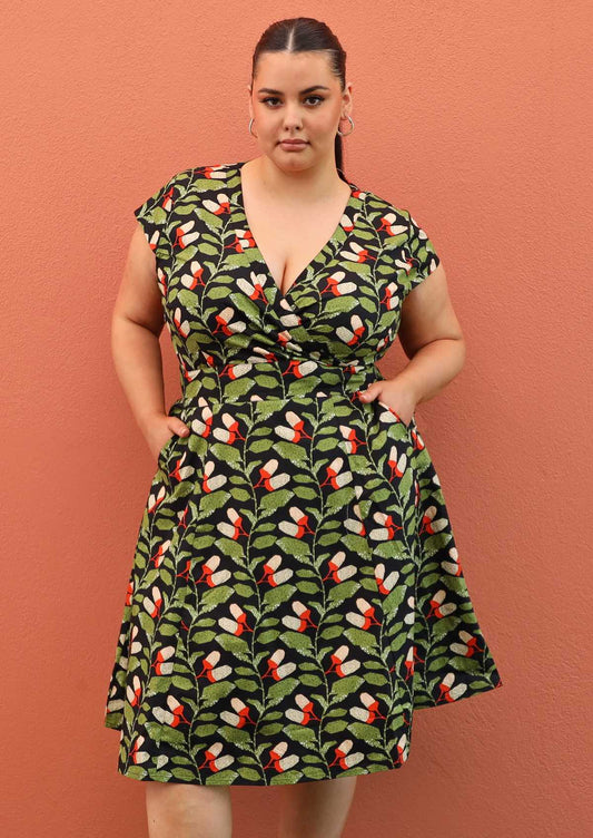 Plus size model wearing retro style cotton Alice dress in black and green 