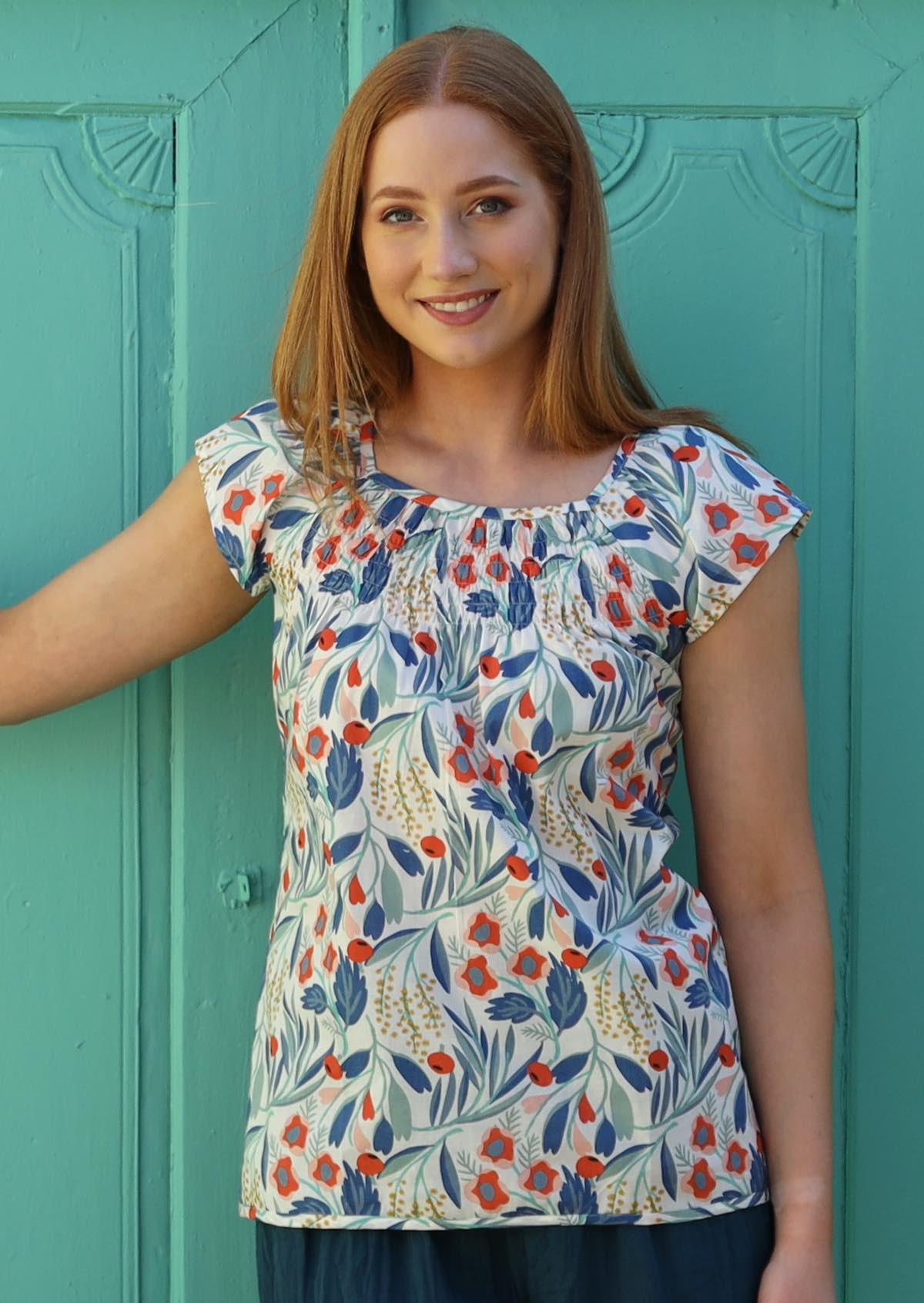 Model wears cotton top with smocking across chest