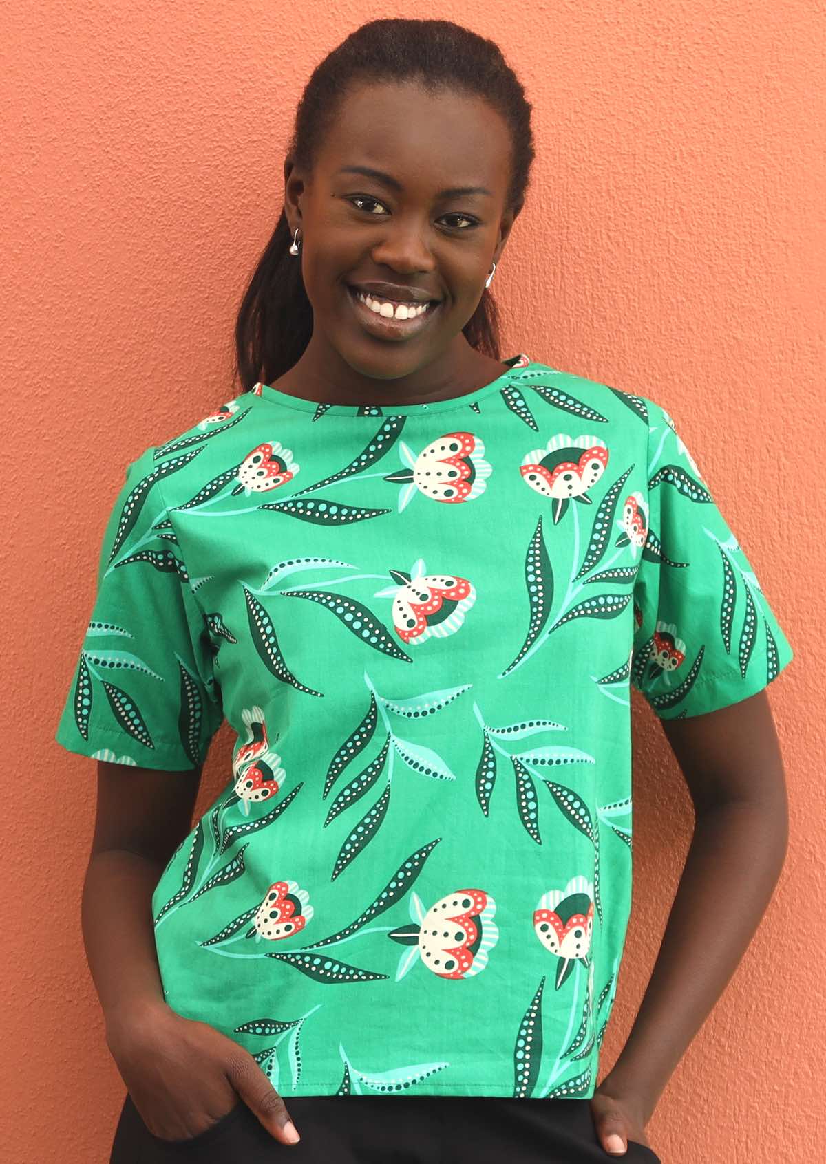 Model wears green cotton short sleeve top