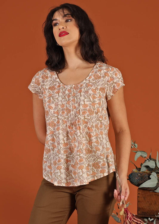 Model wears U-shaped neckline floral top